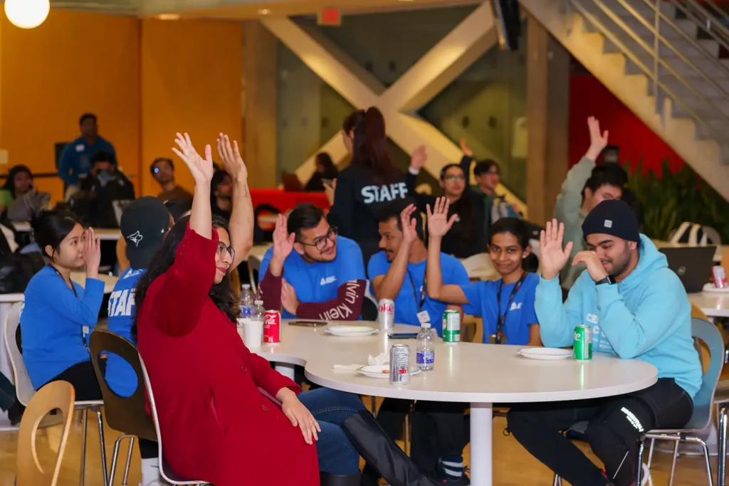 many students with their hands up